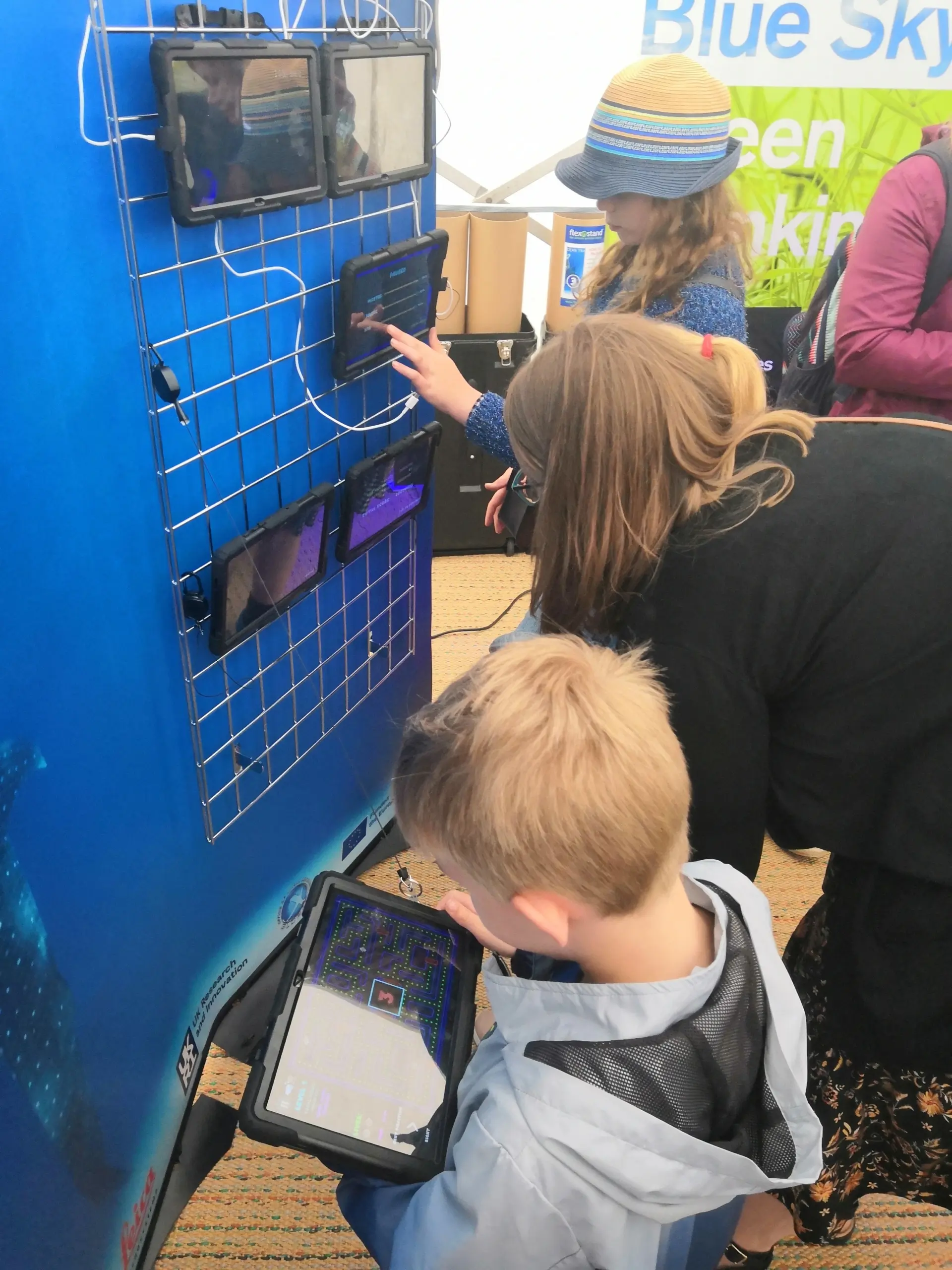 Photo of a parent and child playing an educational video game on a tablet computer