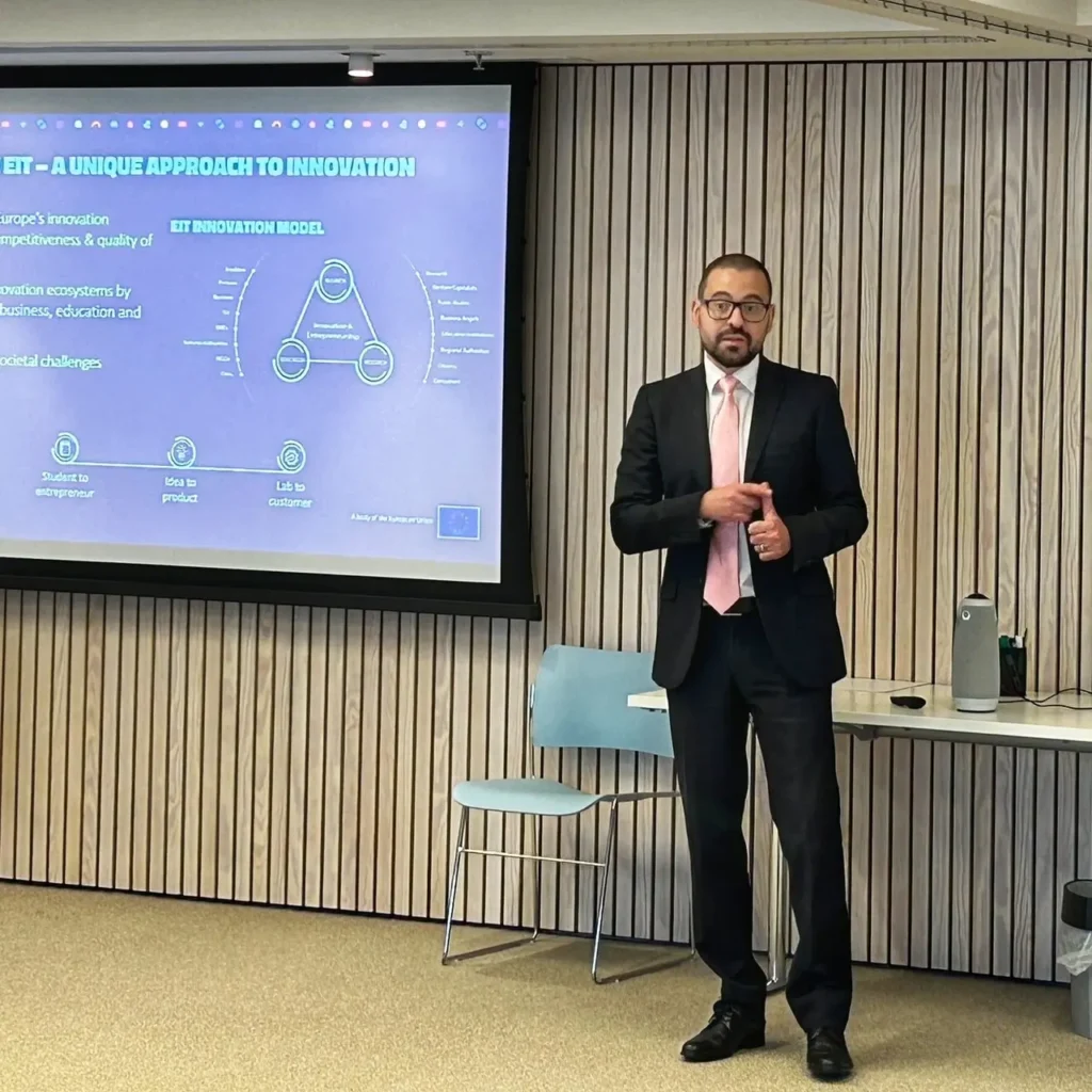 Man in a suit giving a presentation during a workshop