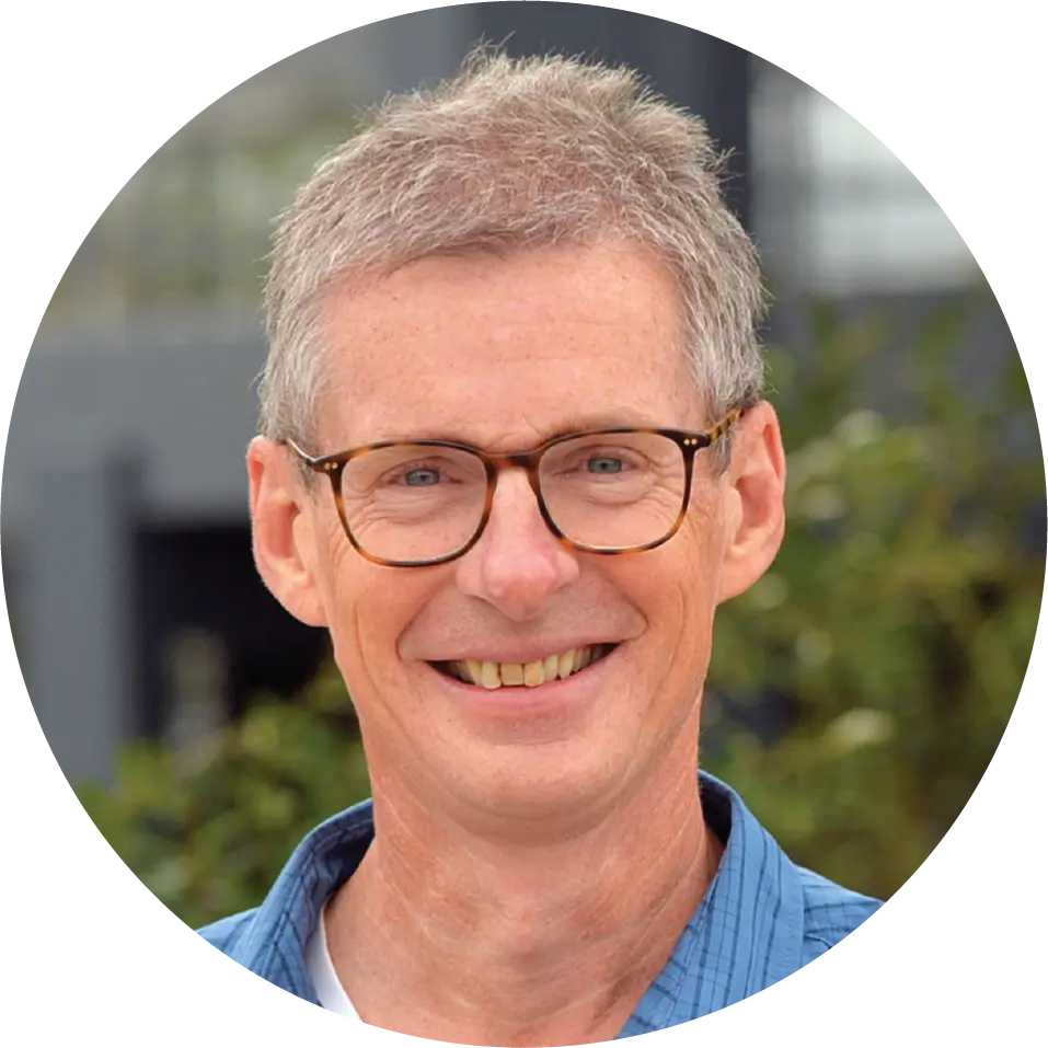 smiling man with short grey hair wearing glasses