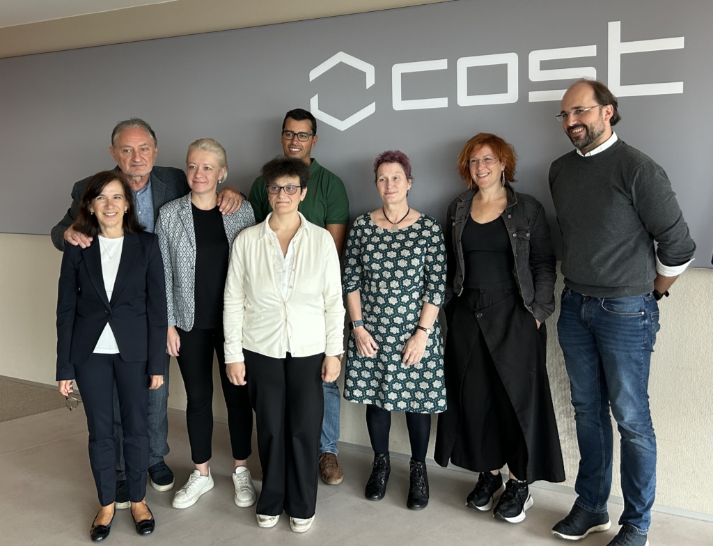 Group photo of 8 speakers at an academic/stakeholder event